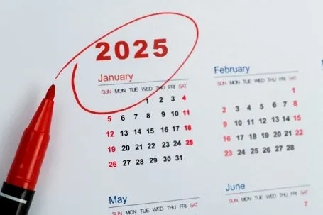 A calendar with January 2025 circled and a red pen.
